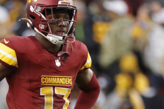 An American football player in a burgundy Commanders jersey with the number 17.