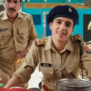 Sanya Malhotra as a police officer at a village stall.
