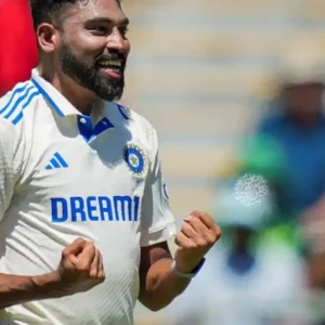 Indian cricketer Mohammed Siraj celebrates taking a wicket during a match.