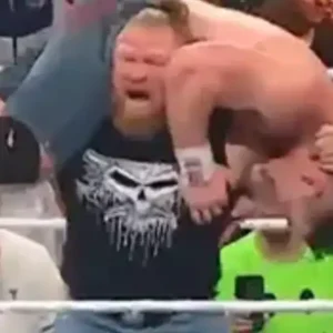 Wrestler Brock Lesnar lifting his opponent onto his shoulders.