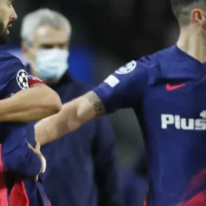 Football players from two teams in a confrontation.