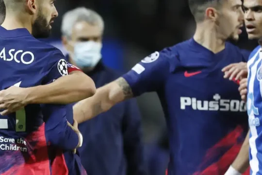 Football players from two teams in a confrontation.