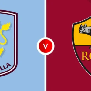 The Aston Villa and Roma football club logos are displayed on a split background.